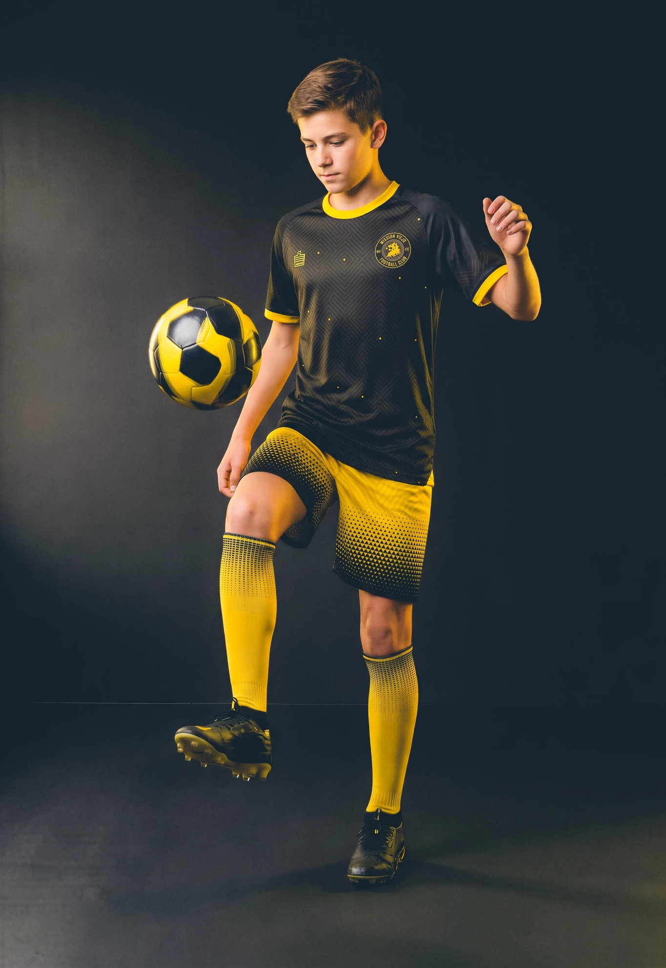 Mission Viejo FC player in the black, crimson, and gold away kit